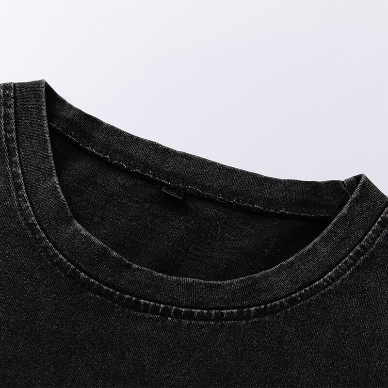 Close-up of the neckline of a loose black cotton T-shirt, showcasing gothic style and soft fabric texture.