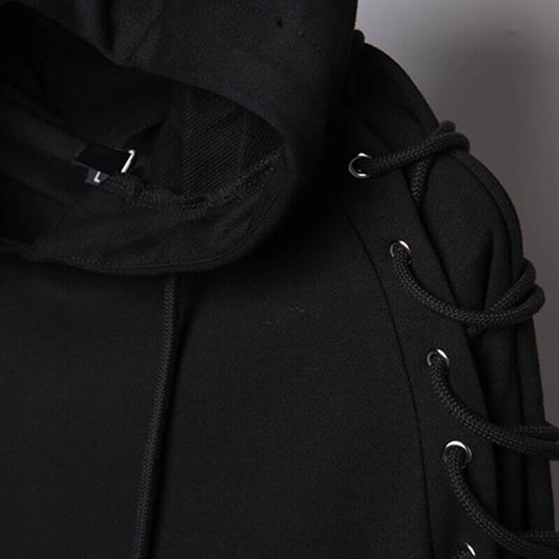 Close-up of black hooded sweatshirt showcasing unique lace detail on shoulders and cozy interior.