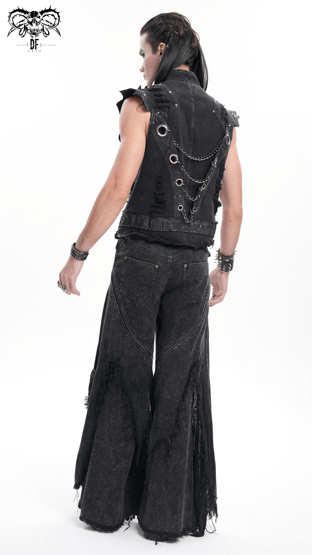 Stylish man wearing a loose, distressed black outfit with wide-leg pants and chains, perfect for urban streetwear looks.
