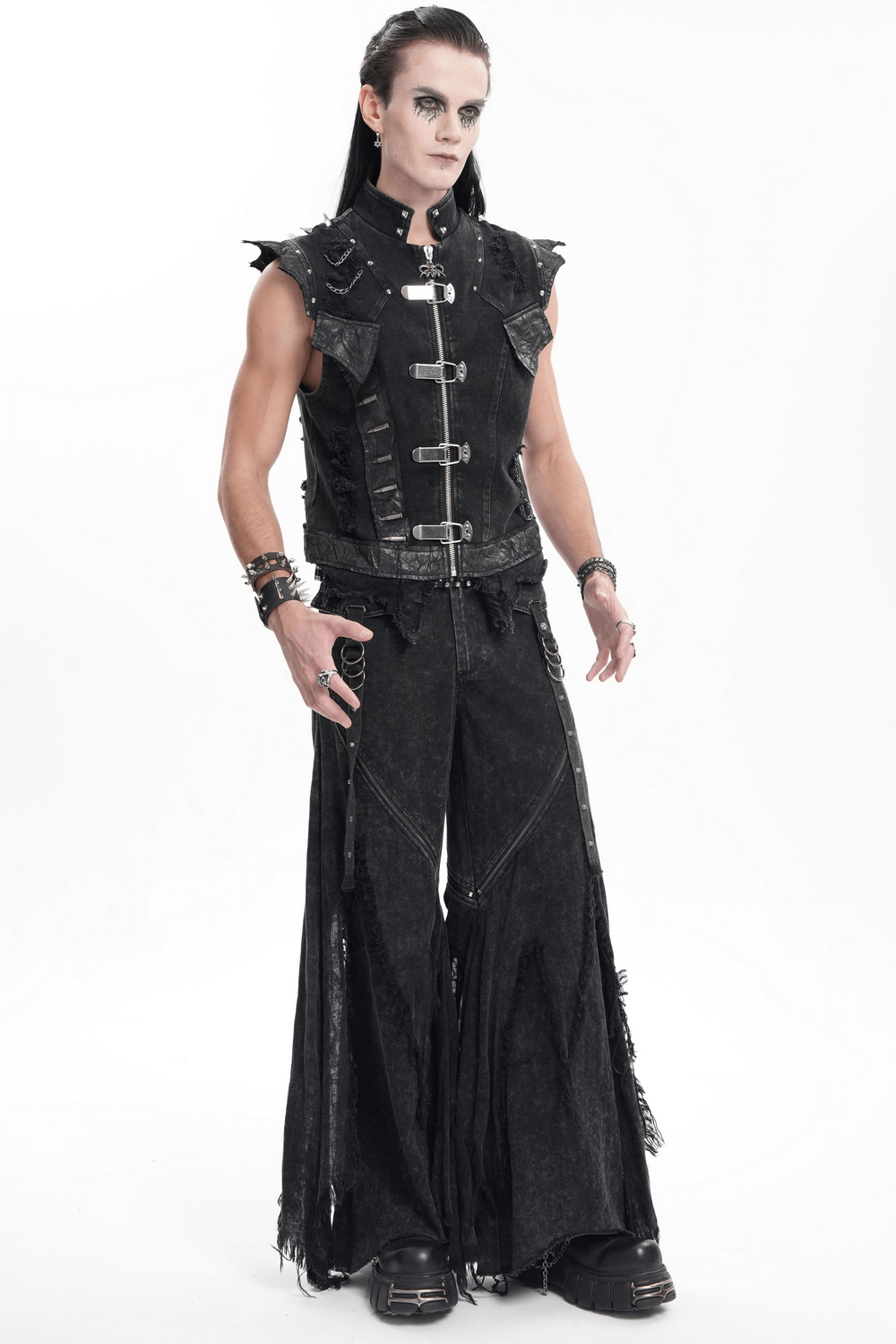 Edgy fashion model in sleeveless vest and wide-leg distressed black jeans, showcasing urban streetwear style.