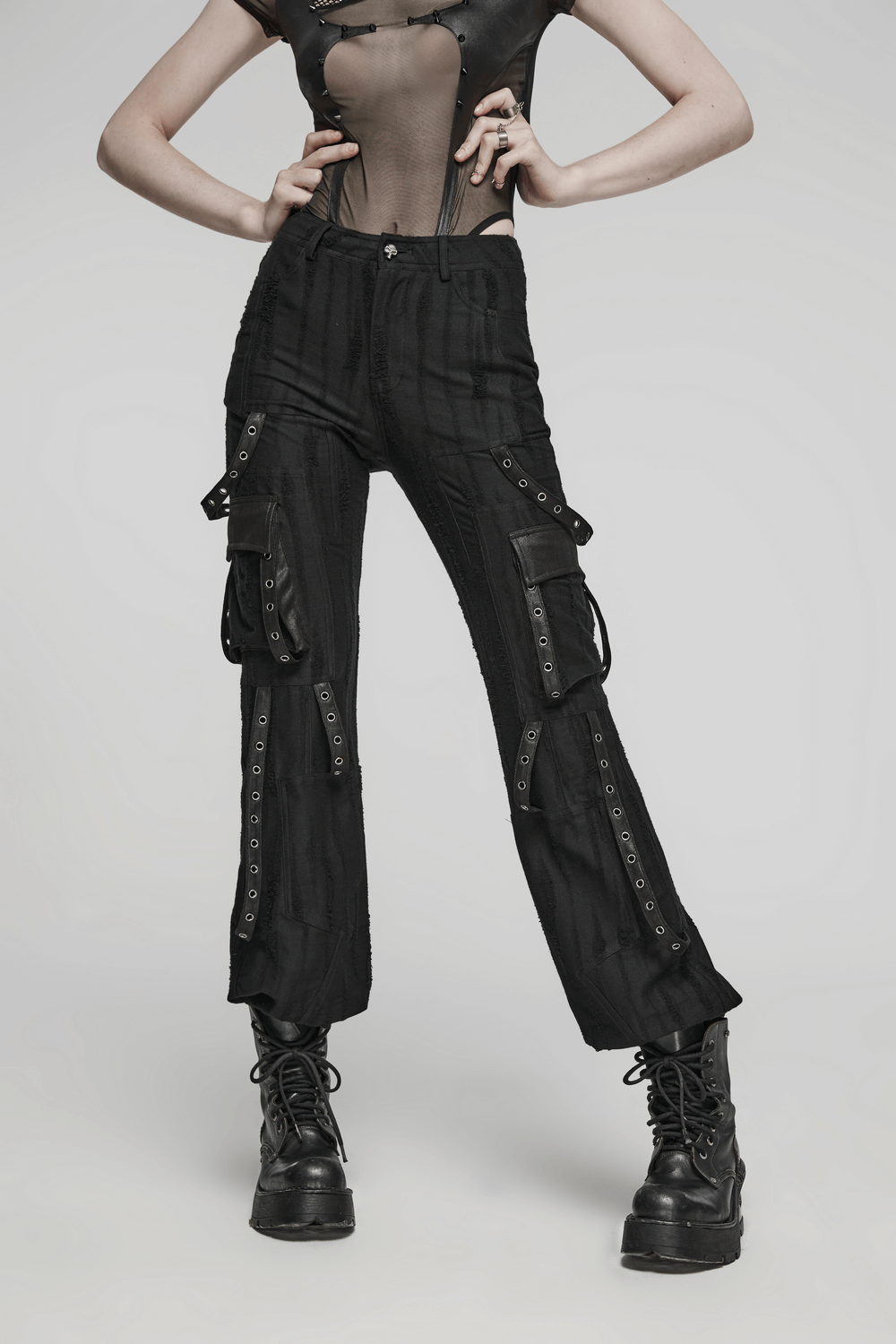 Loose-fit black gothic streetwear cargo pants with o-ring details and eyelet webbing.