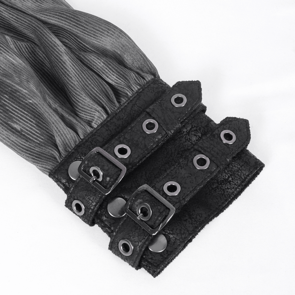 Close-up of dark off-shoulder top's buckled cuffs with metal accents showcasing gothic elegance and style.