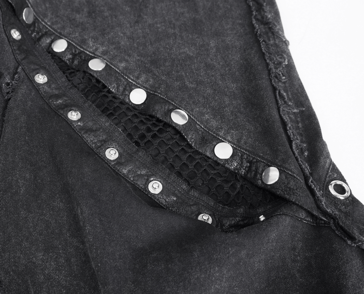 Close-up of black punk flared pants featuring eyelets and button closure, showcasing a gothic vibe.