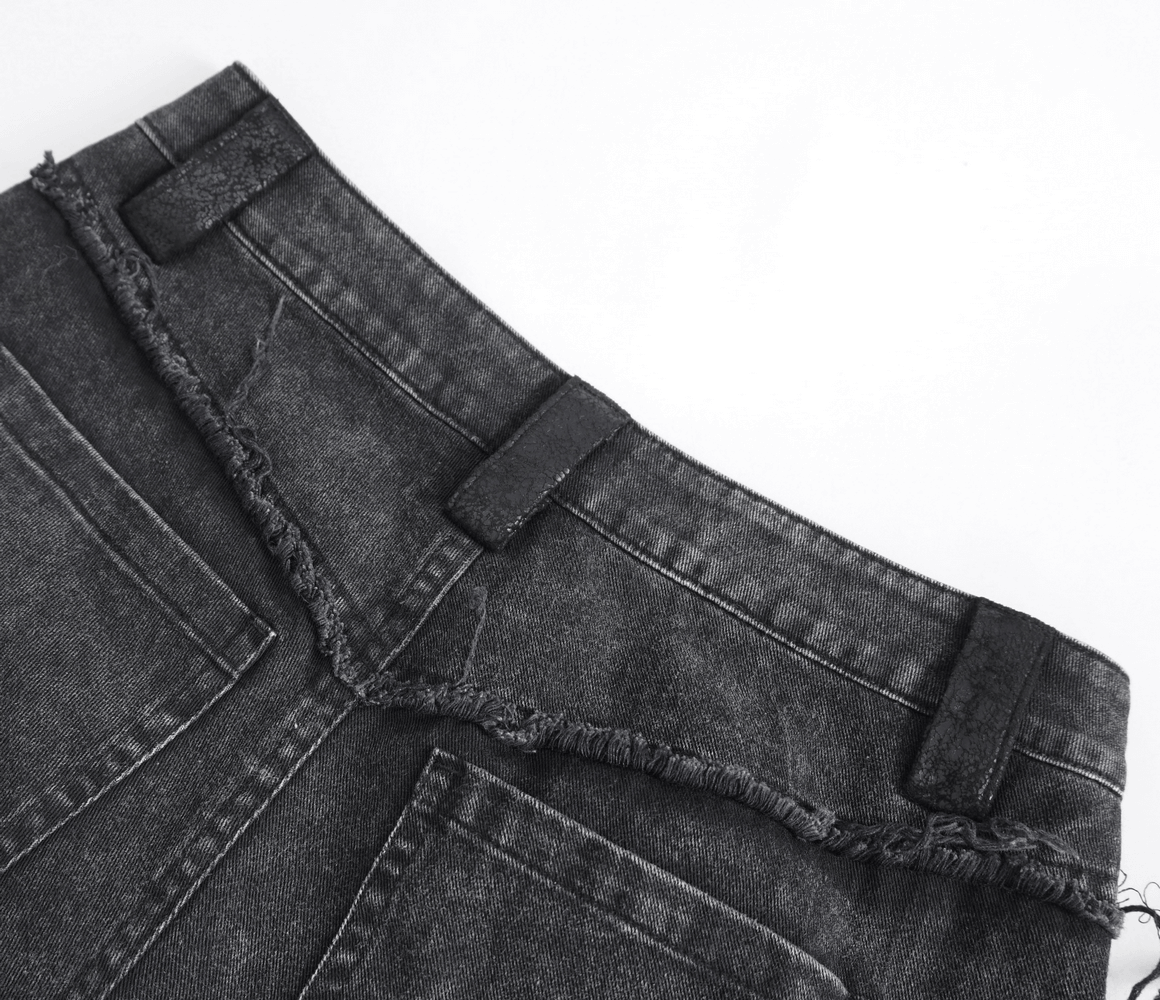 Close-up of the waistline of loose punk eyelets flared pants, showcasing unique frayed edges and button closures.