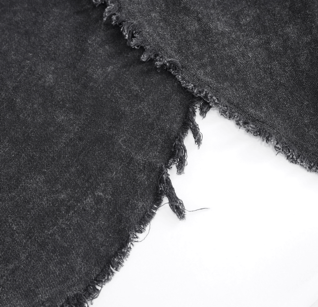 Close-up of rugged black fabric with frayed edges, perfect for punk-inspired gothic fashion.