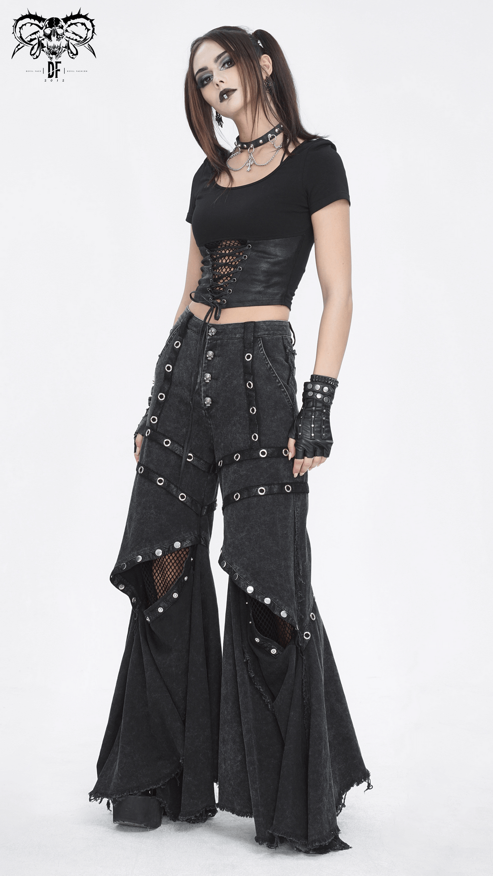 Gothic punk flared pants with eyelets and buttons worn by a model, exuding a dramatic street style.