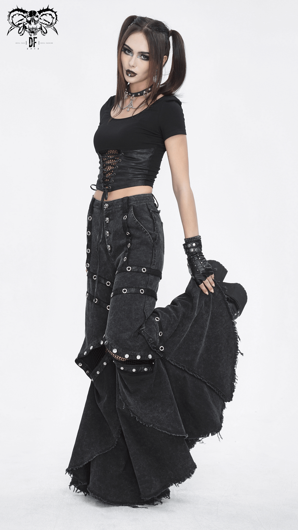 Gothic women in loose punk eyelets long flared pants, showcasing a dramatic punk rock style with unique buttons.