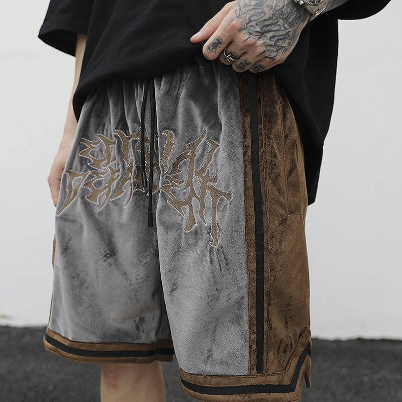 Stylish men's loose shorts with drawstring, featuring vibrant contrast embroidery and a trendy design for summer wear.