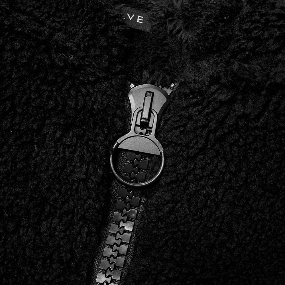 Close-up of the zipper detail on a black fluffy women's jacket with soft texture and cozy design.