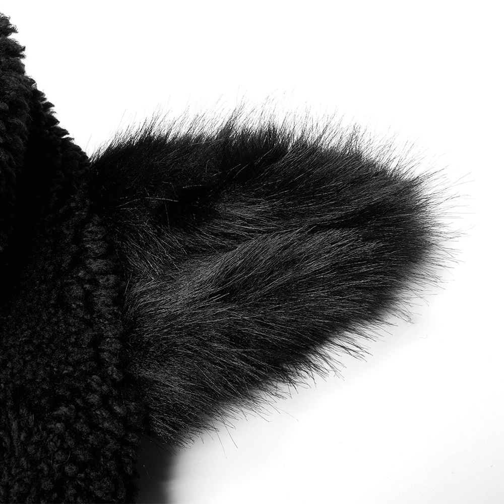 Close-up of soft black fox ear detail on a warm hooded jacket for women.