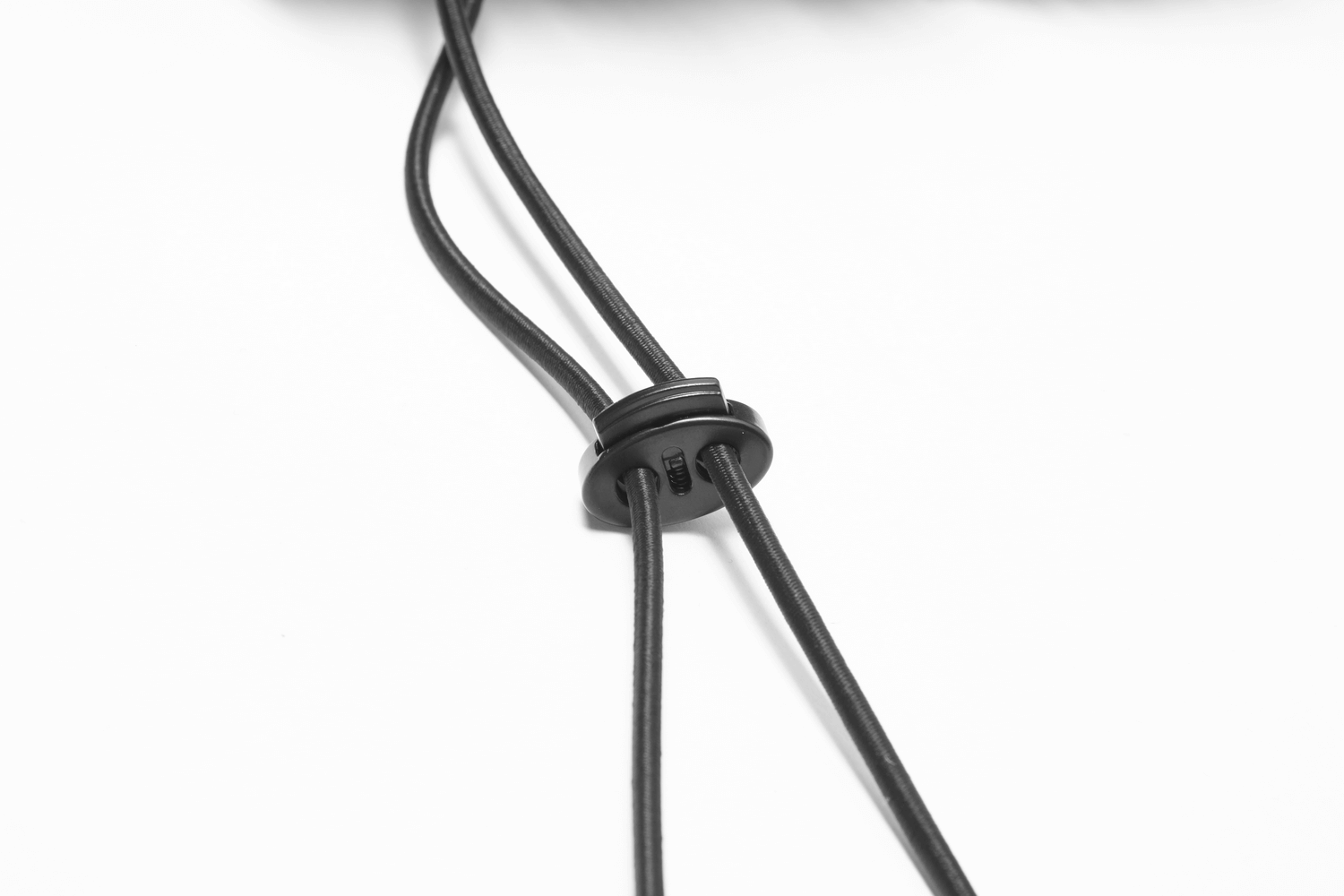 Close-up of adjustable rubber drawcord for customizable fit on a women's fluffy jacket.