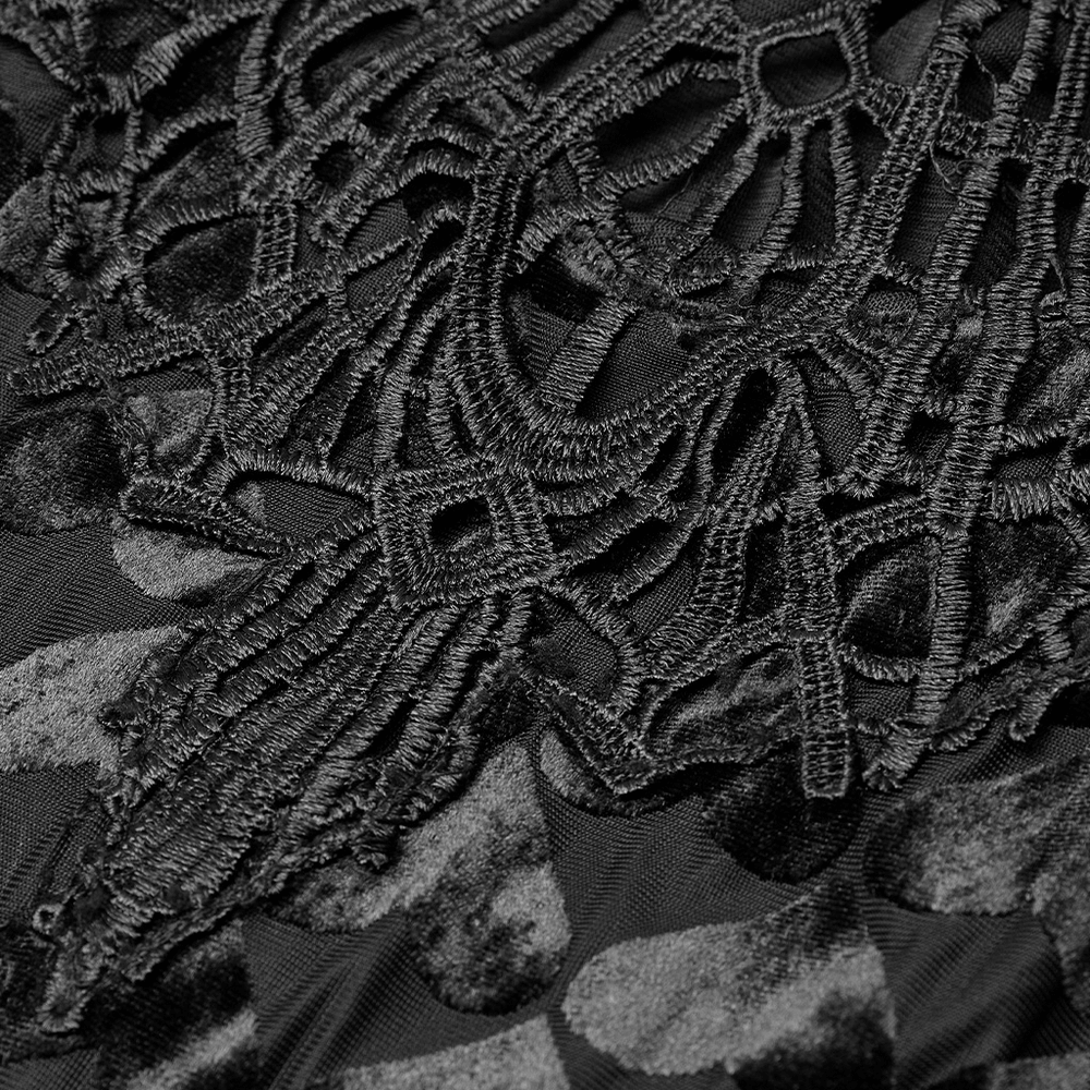 Close-up of the intricate hollow-out lace design on a black velvet dress, showcasing gothic elegance.
