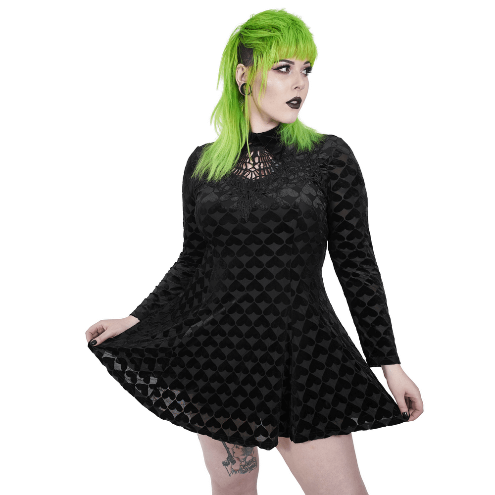 Gothic velvet dress with heart patterns, featuring a hollow-out design and a model showcasing a bold style.