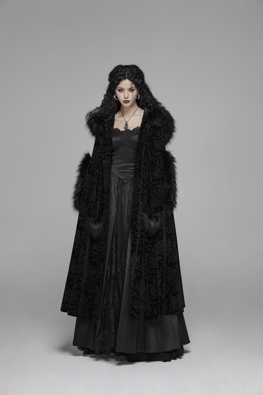 Elegant lady in a luxurious black velvet hooded Gothic cloak showcasing nocturnal elegance.