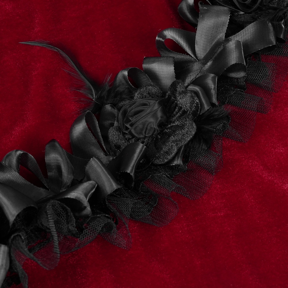 Burgundy velvet fabric with intricate black lace trim and floral accents from a Gothic Lolita dress