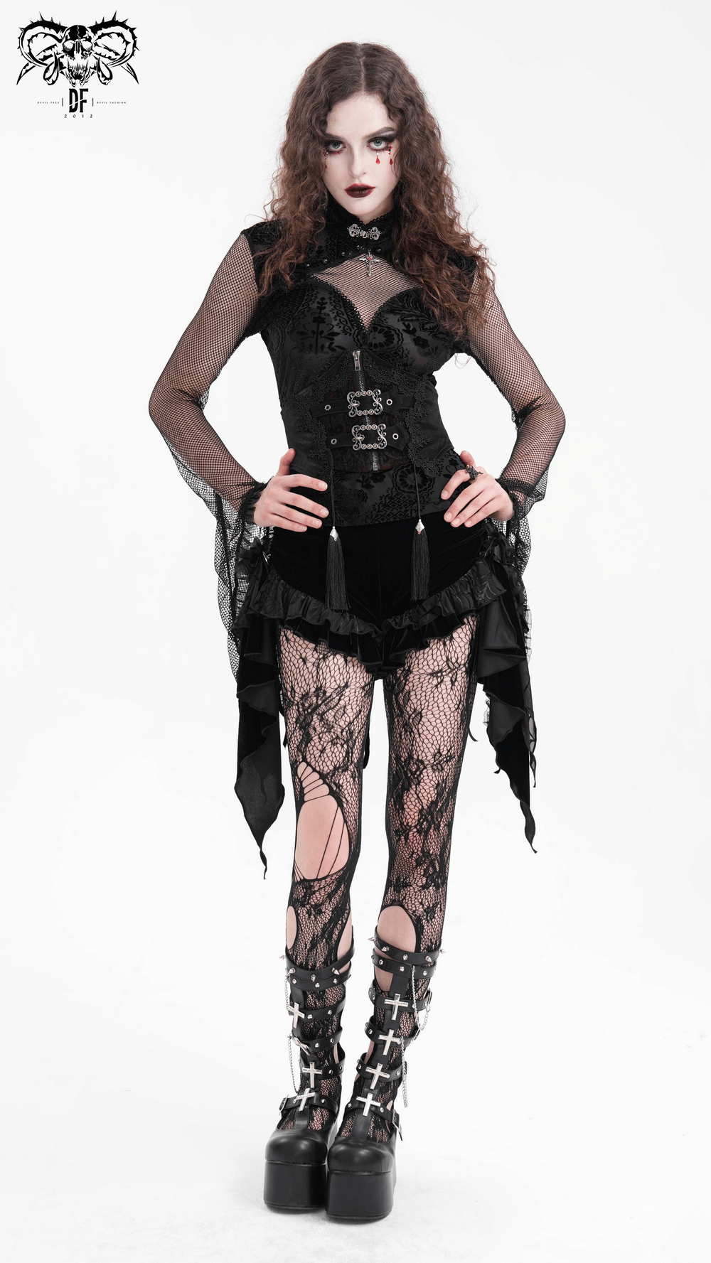 Model showcasing gothic female outfit with black corset, ruffled skirt, fishnet tights, and chunky platform boots.