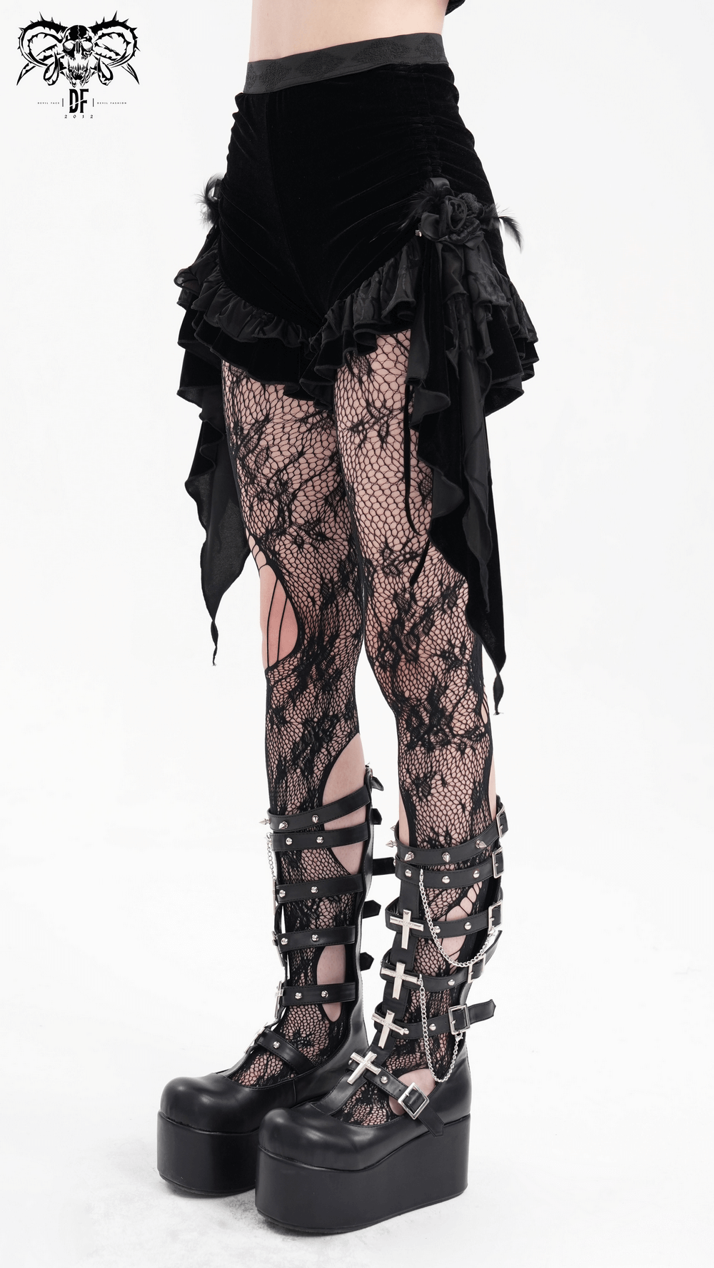 Luxurious gothic velvet shorts with ruffles and feathers paired with fishnet tights and platform boots.