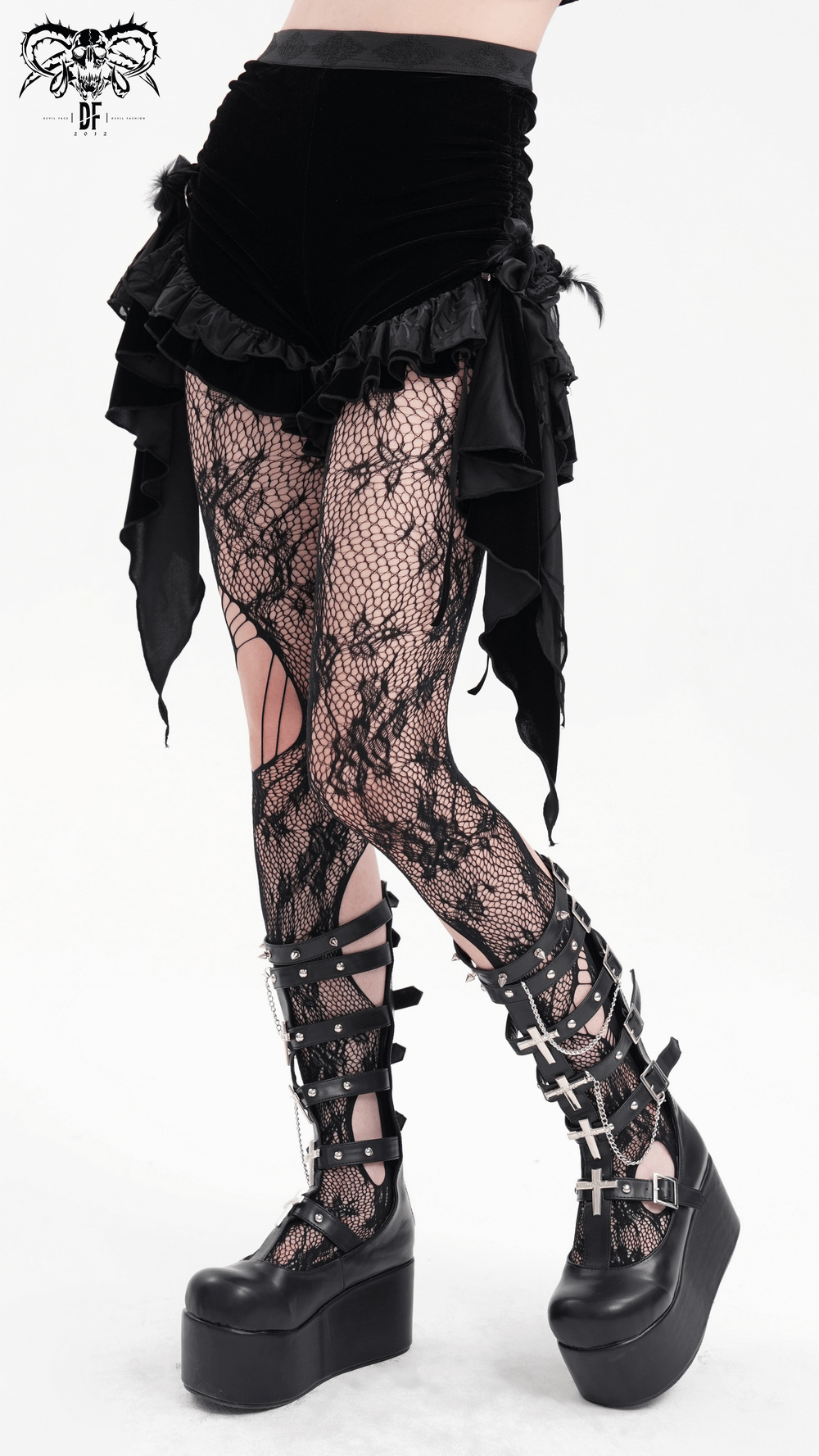 Luxurious gothic velvet shorts with cascading ruffles, paired with stunning fishnet tights and platform boots.