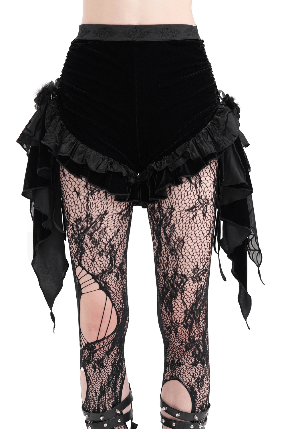 Luxurious black velvet shorts with cascading ruffles and feather details, styled with fishnet tights for a gothic look.