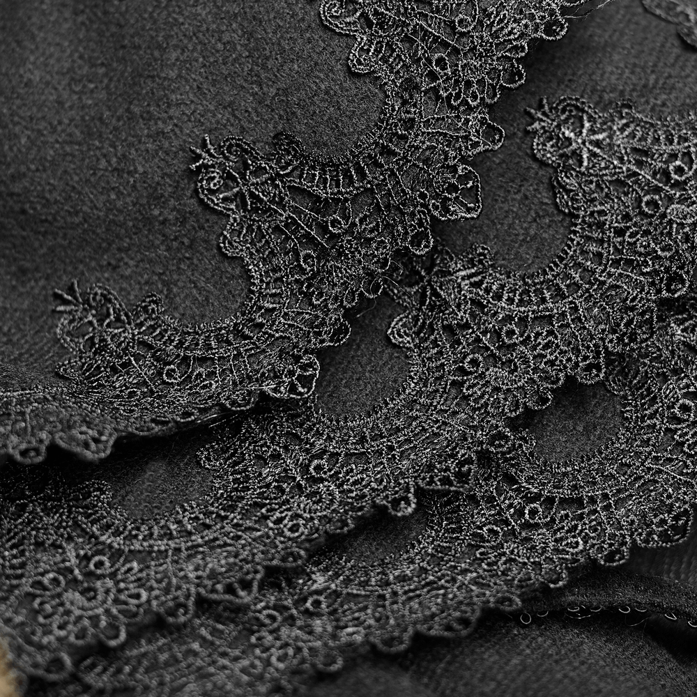 Close-up of ornate black lace detail on luxurious wool fabric, showcasing gothic elegance.