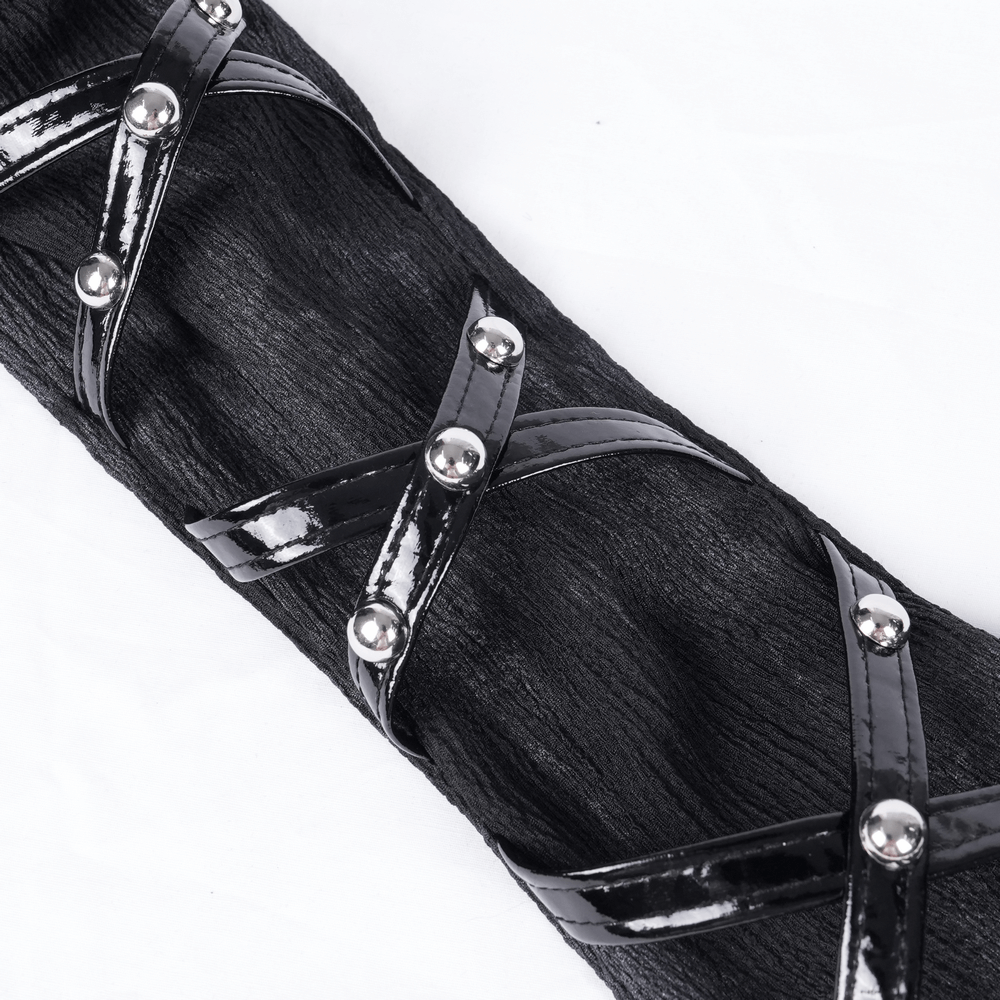 Close-up of black lace opera glove with rivet straps and shiny metal accents for gothic punk flair.