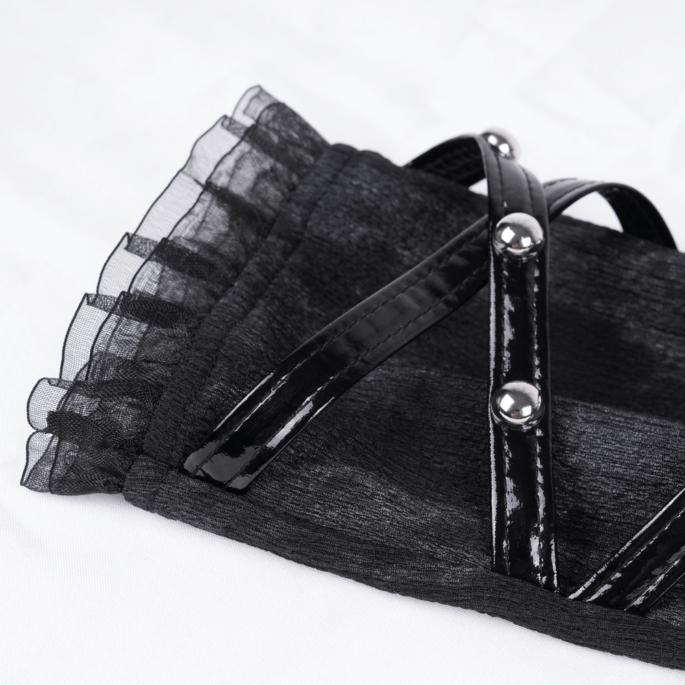 Close-up of luxurious gothic punk long gloves featuring lace ruffles and shiny rivet straps.