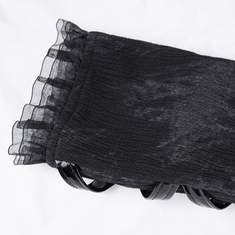 Close-up of luxurious black lace opera glove featuring frilled edges and shiny rivet straps, perfect for gothic style.