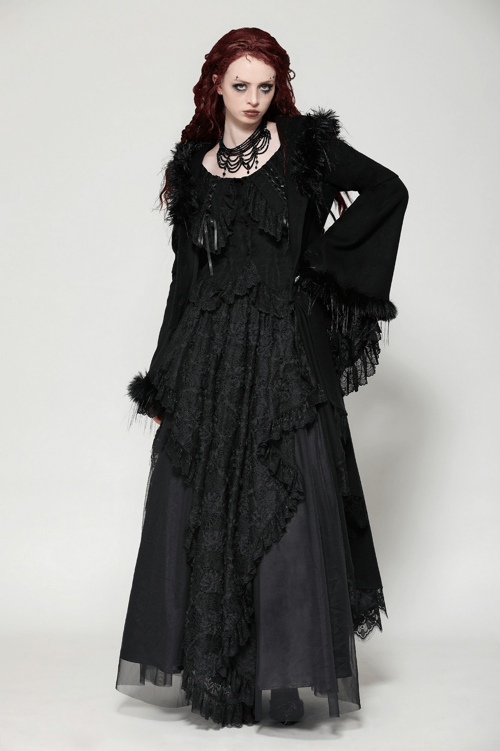 Elegant woman in a black lace-trimmed gothic coat with a dramatic hood and faux fur, exuding a mystical vibe.