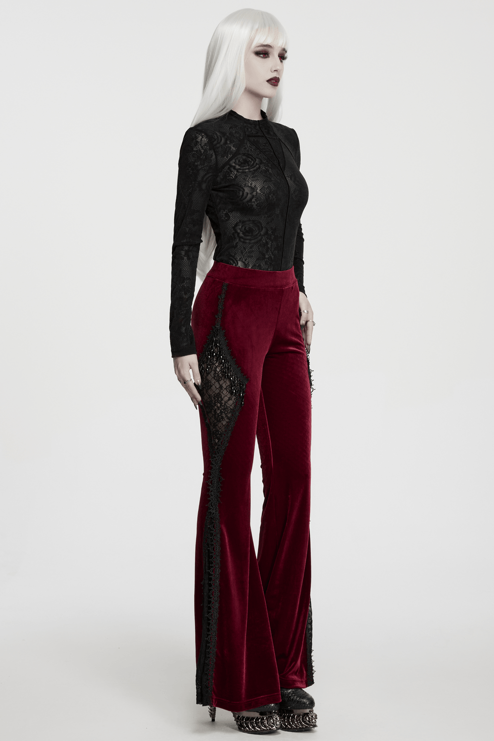 Luxurious Velvet Flared Pants with Lace Side Panels showcased on a model, featuring deep red velvet and intricate lace details.