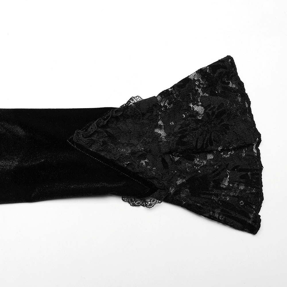 Close-up of a black velvet sleeve adorned with intricate lace detailing for a gothic dress.
