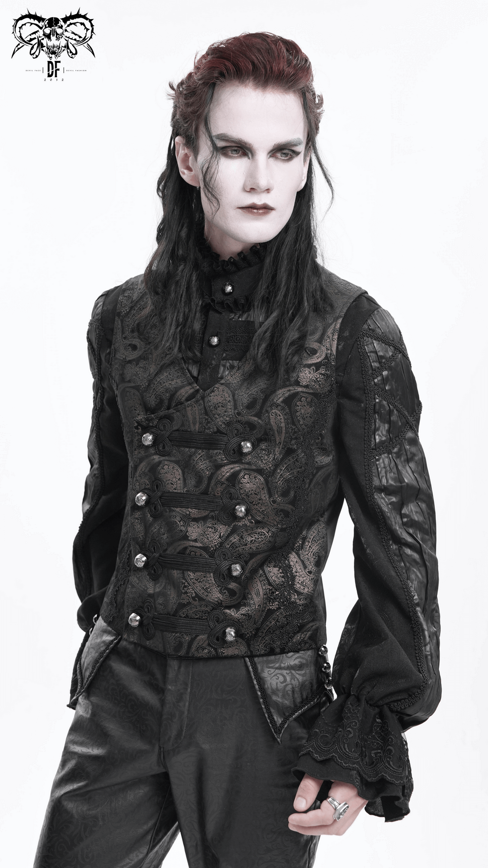 Male model in a gothic waistcoat with ornate button detailing and long sleeves, embodying vintage elegance and dark fashion.