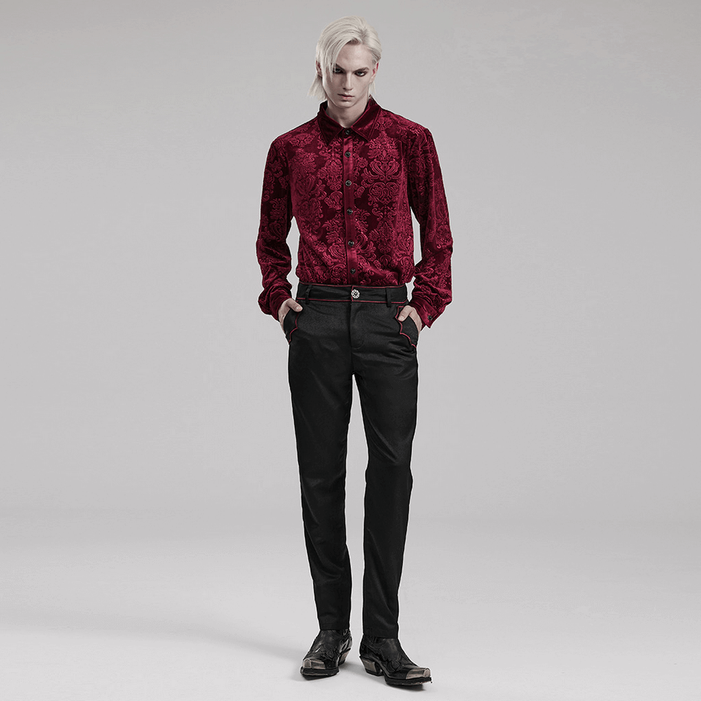 Stylish model in elegant red velvet gothic floral shirt and black pants, showcasing luxury and sophistication.