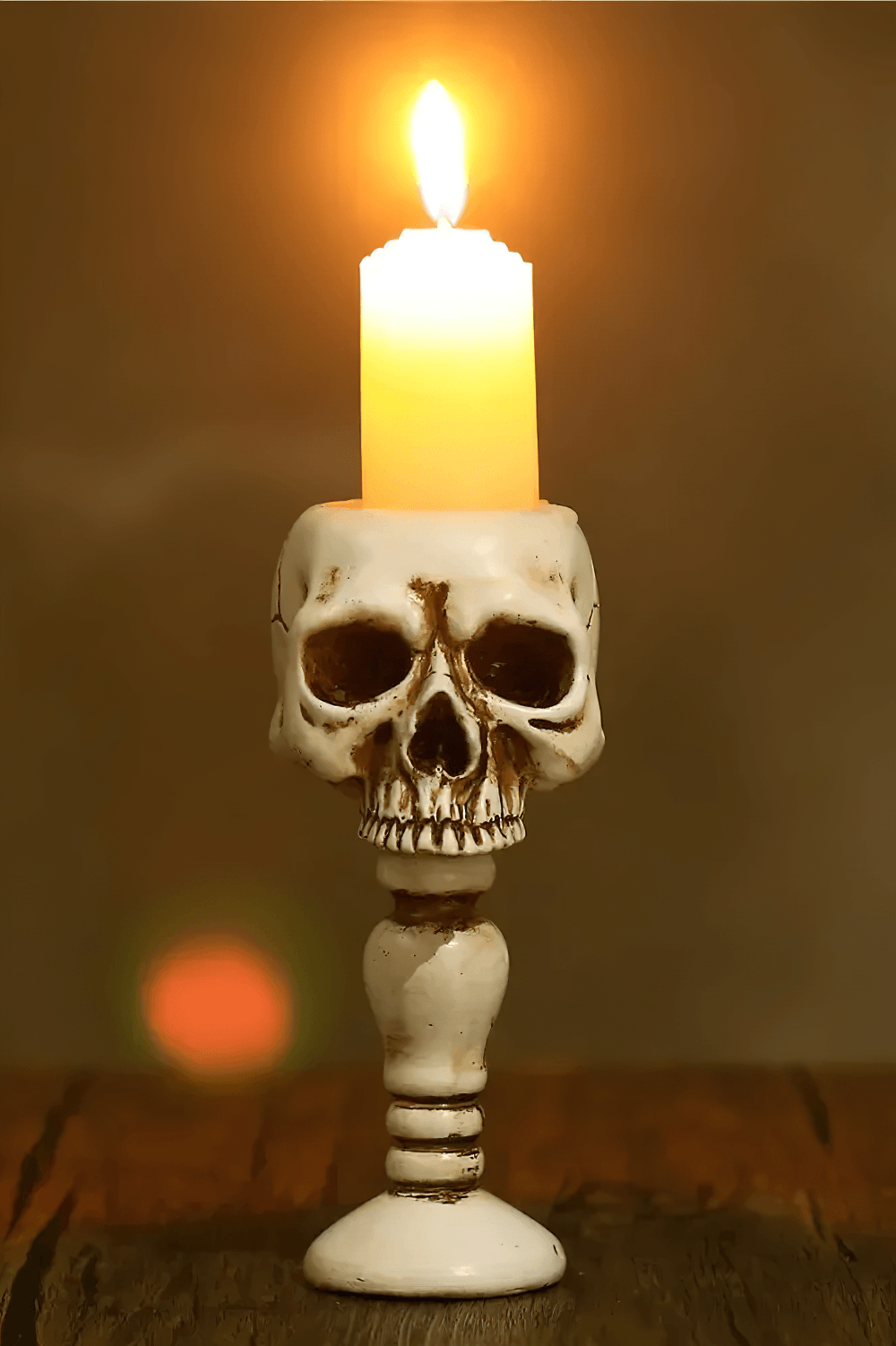 Macabre Skeleton Candle Stand for Haunted Decor with eerie skull design and glowing candle.