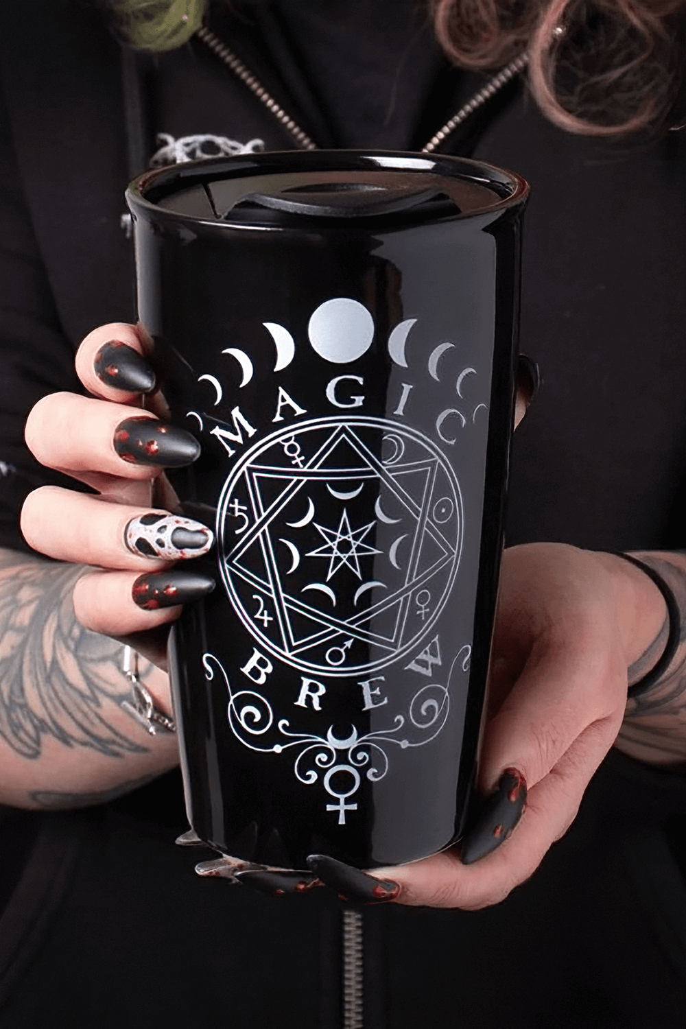 Black travel mug with occult design reading 'Magic Brew', perfect for witchy souls and coffee lovers.
