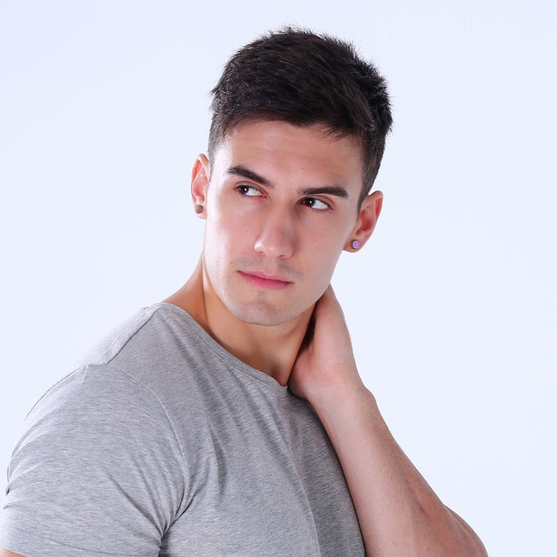 Stylish man wearing magnetic stud earrings, showcasing a chic and classy look in a gray t-shirt.