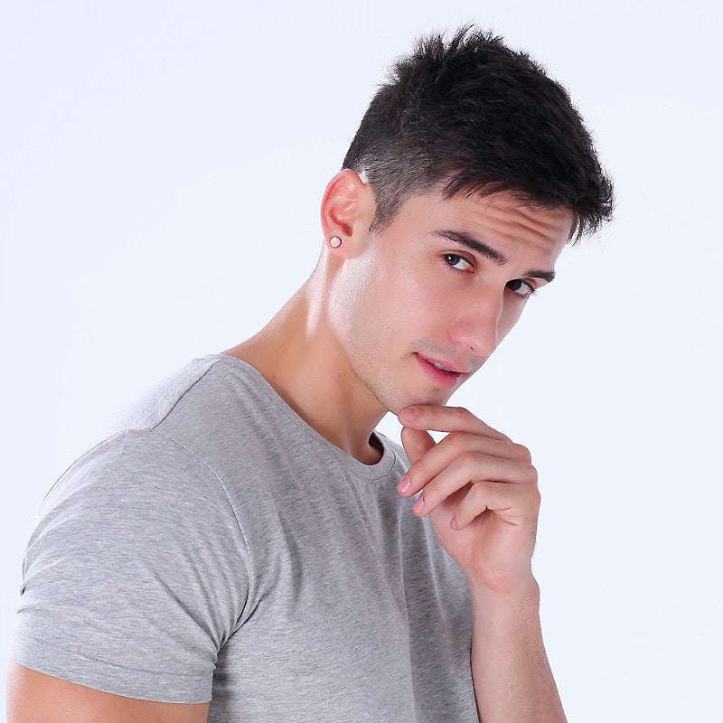Stylish man wearing magnetic stud earrings, showcasing stainless steel jewelry for a classy look.