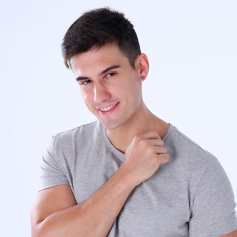 Stylish man showcasing magnetic stud earrings in stainless steel, looking confident and classy in a gray t-shirt.