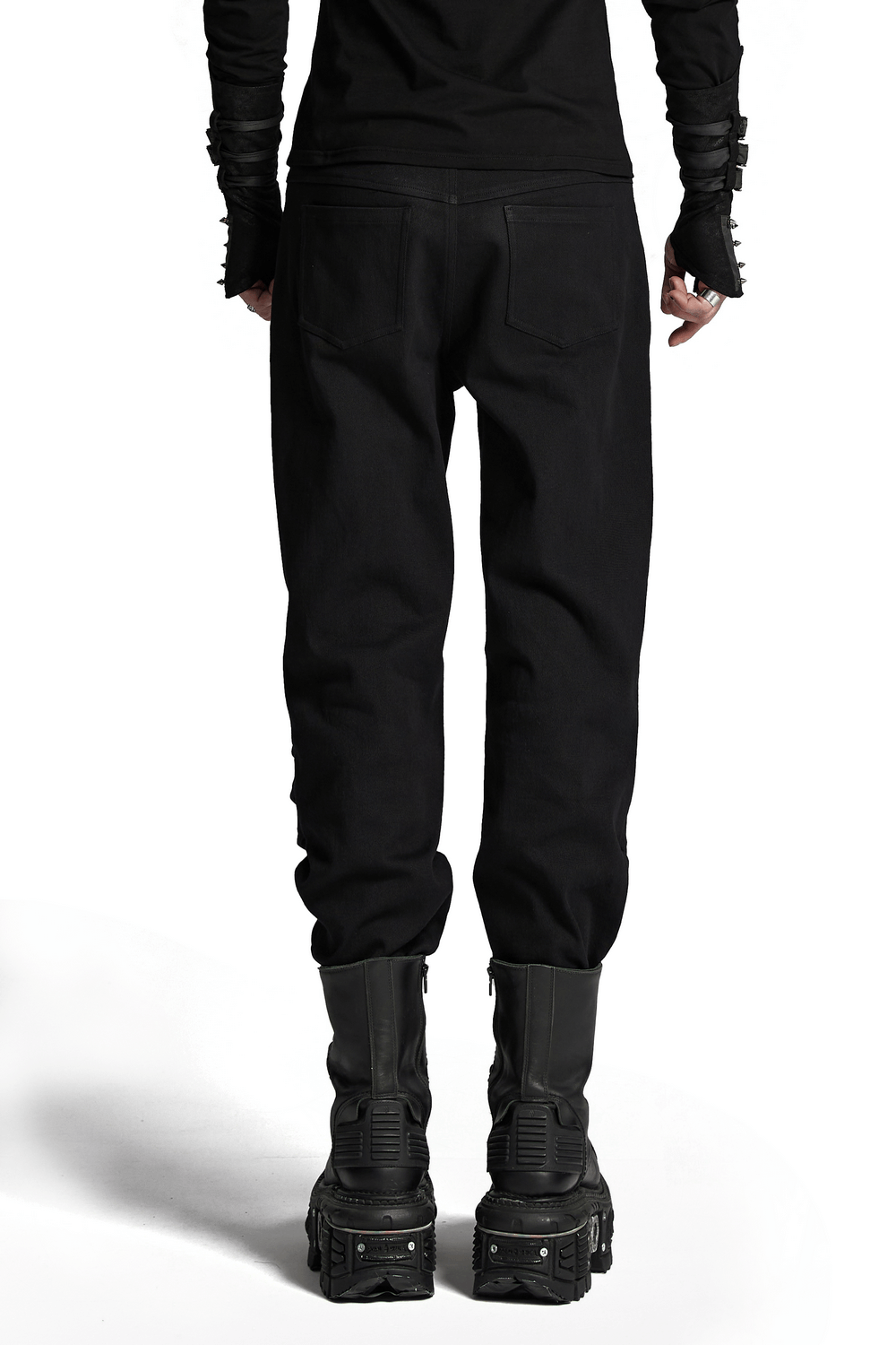 Black cyberpunk pants with 3D armor patches, showcasing stylish back view with chunky boots.