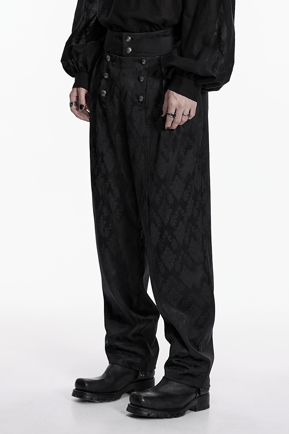 Male Black Gothic Jacquard Tapered Fit Trousers styled with a dark, ornate patterned fabric and a high waistband.