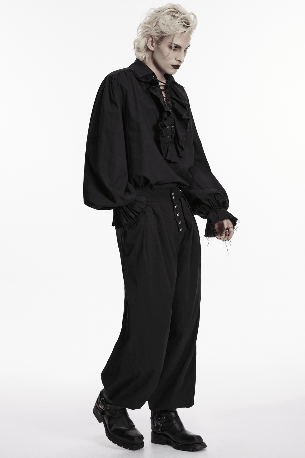 Male Black Gothic Pleated Lantern Tapered Pants worn with a stylish black blouse and boots, showcasing a dark aesthetic.