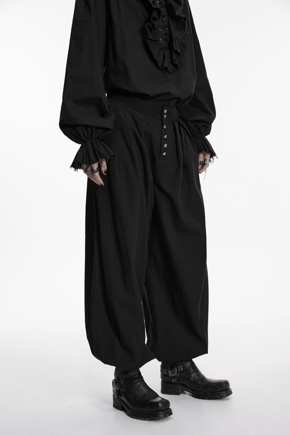 Male Black Gothic Pleated Lantern Tapered Pants styled with a ruffled black shirt and chunky black boots.