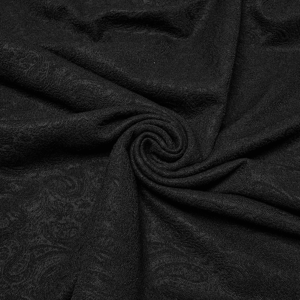 Close-up of textured black jacquard fabric, perfect for gothic fashion, showcasing intricate pattern details.