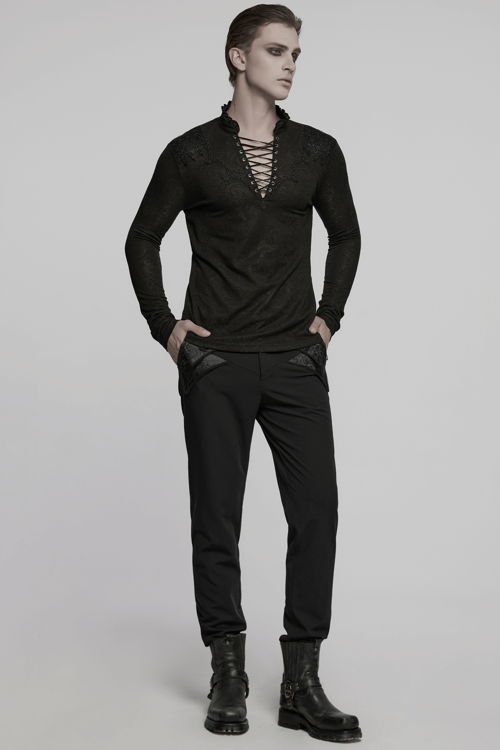 Male black lace-up gothic top with ruffled collar, styled with dark pants for a striking goth fashion statement.