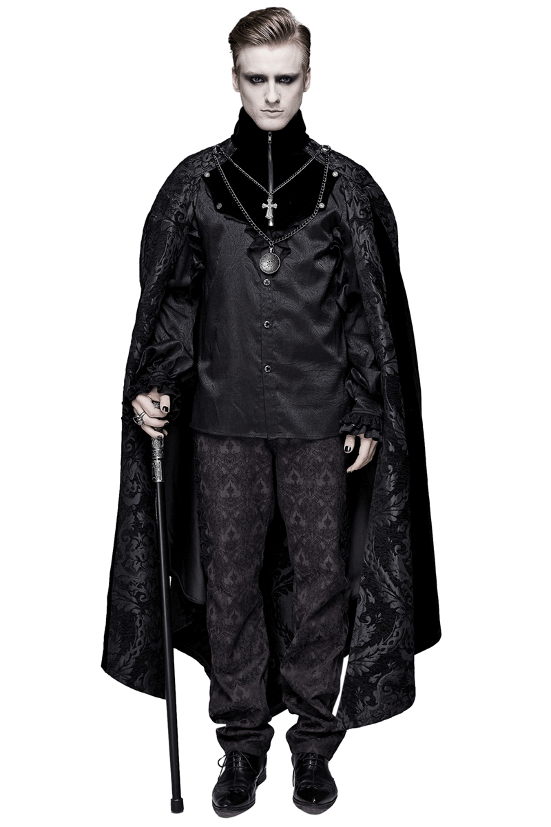 Elegant male model in black gothic long cloak with stand-up collar and medallion necklace, embodying gothic fashion.