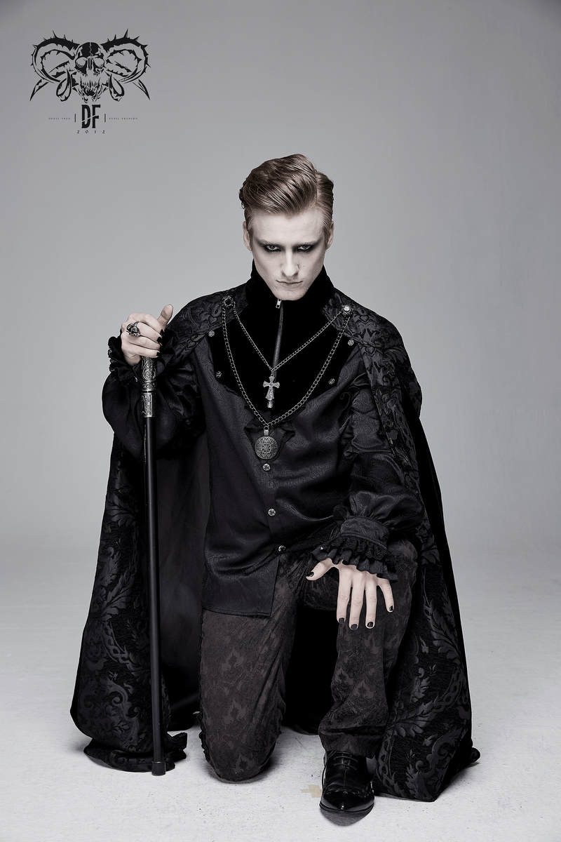Elegant male model in a black gothic long cloak with stand-up collar, featuring a removable cross and medallion necklace.