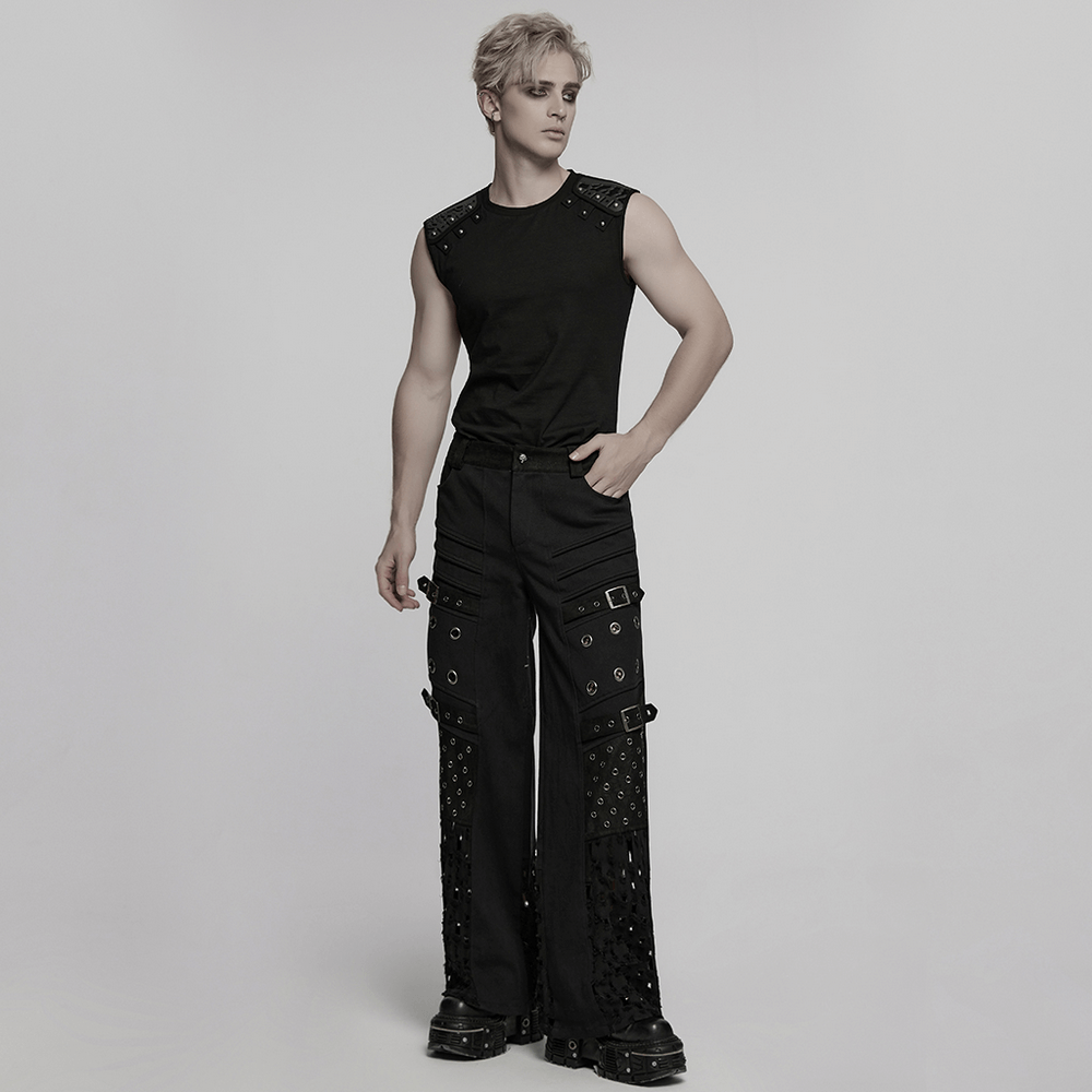 Male model in black punk pants with eyelets and mesh panels, showcasing a bold gothic style.