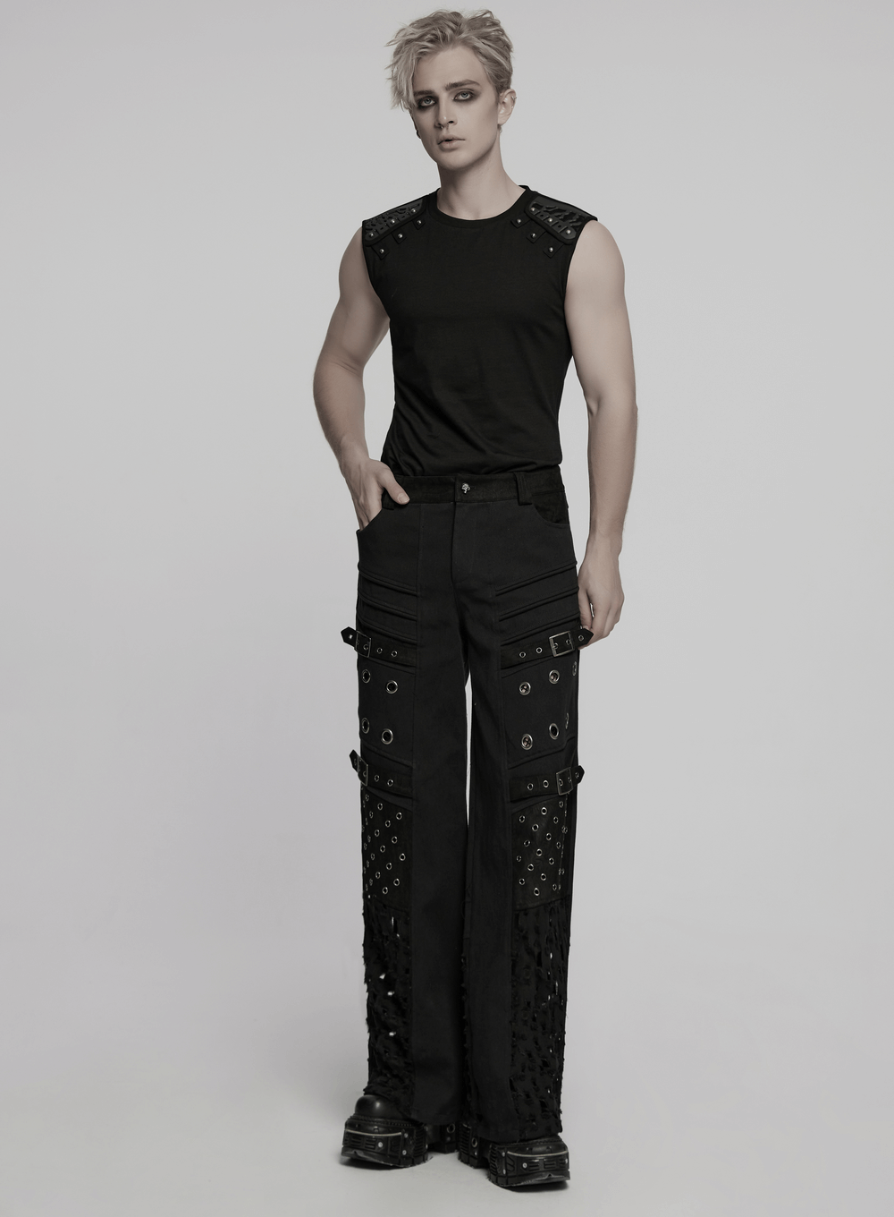 A model showcasing male black punk pants with eyelets and mesh panels, featuring a rebellious gothic cyber style.