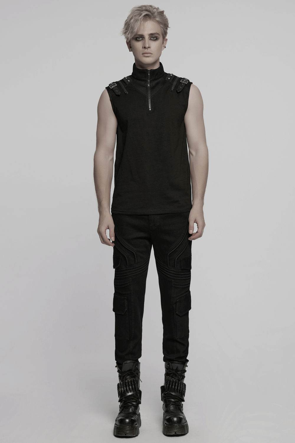 Male model wearing black slim fit punk pants with cargo pockets and a sleeveless top, showcasing edgy street style.