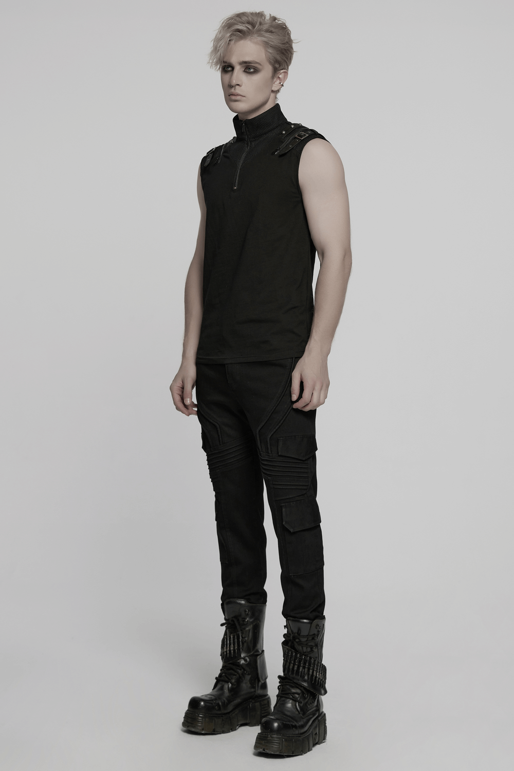 Male model in black slim fit punk pants with cargo pockets, styled with a sleeveless top and combat boots.
