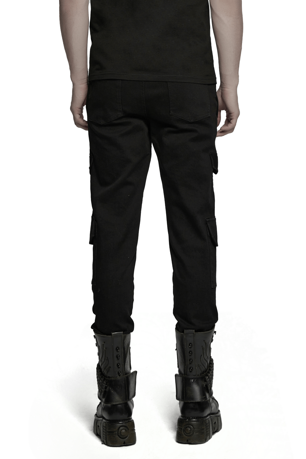 Back view of male model wearing black slim fit punk pants with cargo pockets and combat boots.